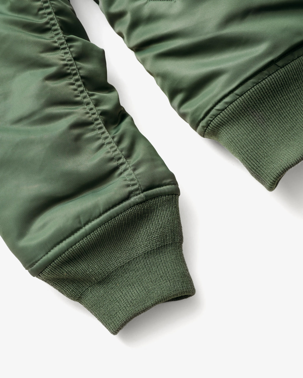 Knit cuff detail shot of sage bomber jacket. See product details for more information.