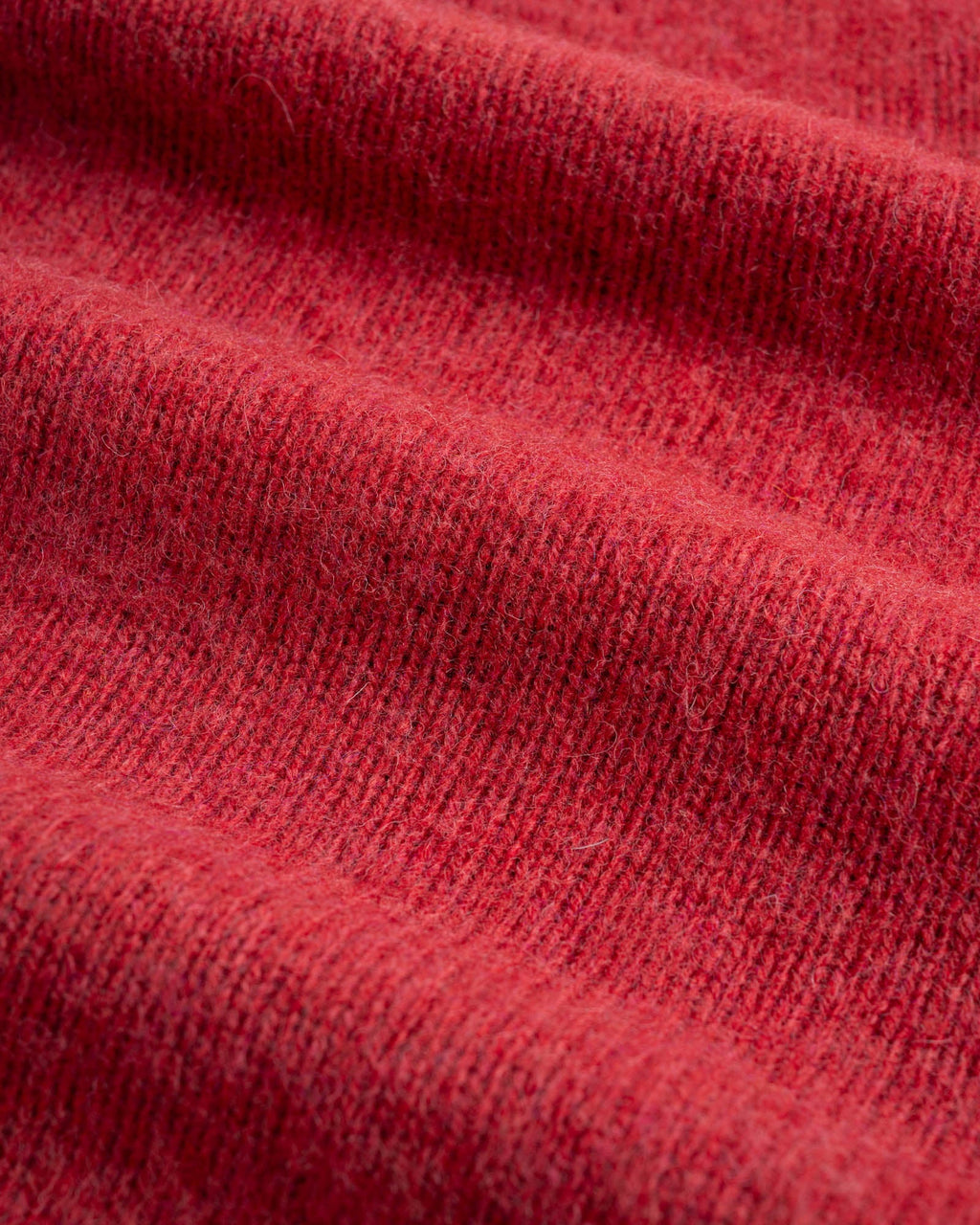 Close-up of red shetland wool fabric used for Birth of the Cool sweater in Velvet Kiss (red).
