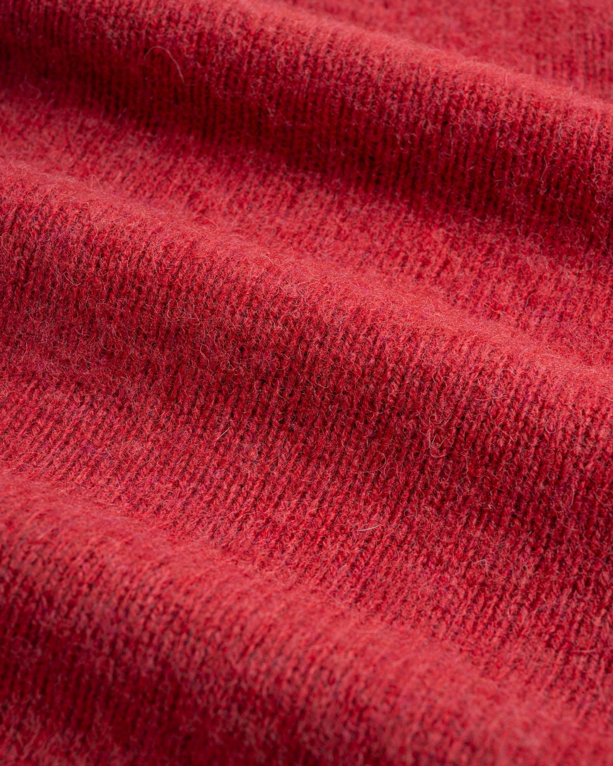 Close-up of red shetland wool fabric used for Birth of the Cool sweater in Velvet Kiss (red).