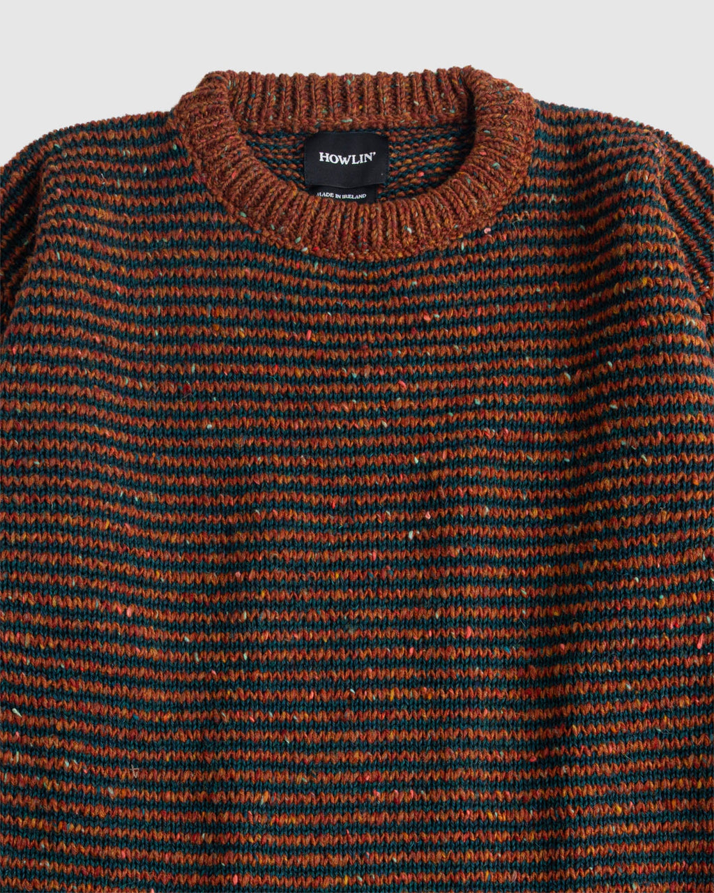 Broken Finger Dream in Cinnamon—black striped sweater on brown field. Flat lay shot close-up of collar. Howlin' label visible. See product description for more details.