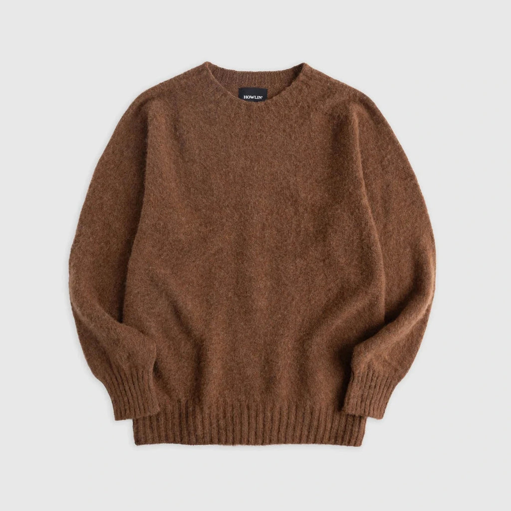 Flat lay of brown shetland wool sweater. Howlin' label visible. See product description for more details.