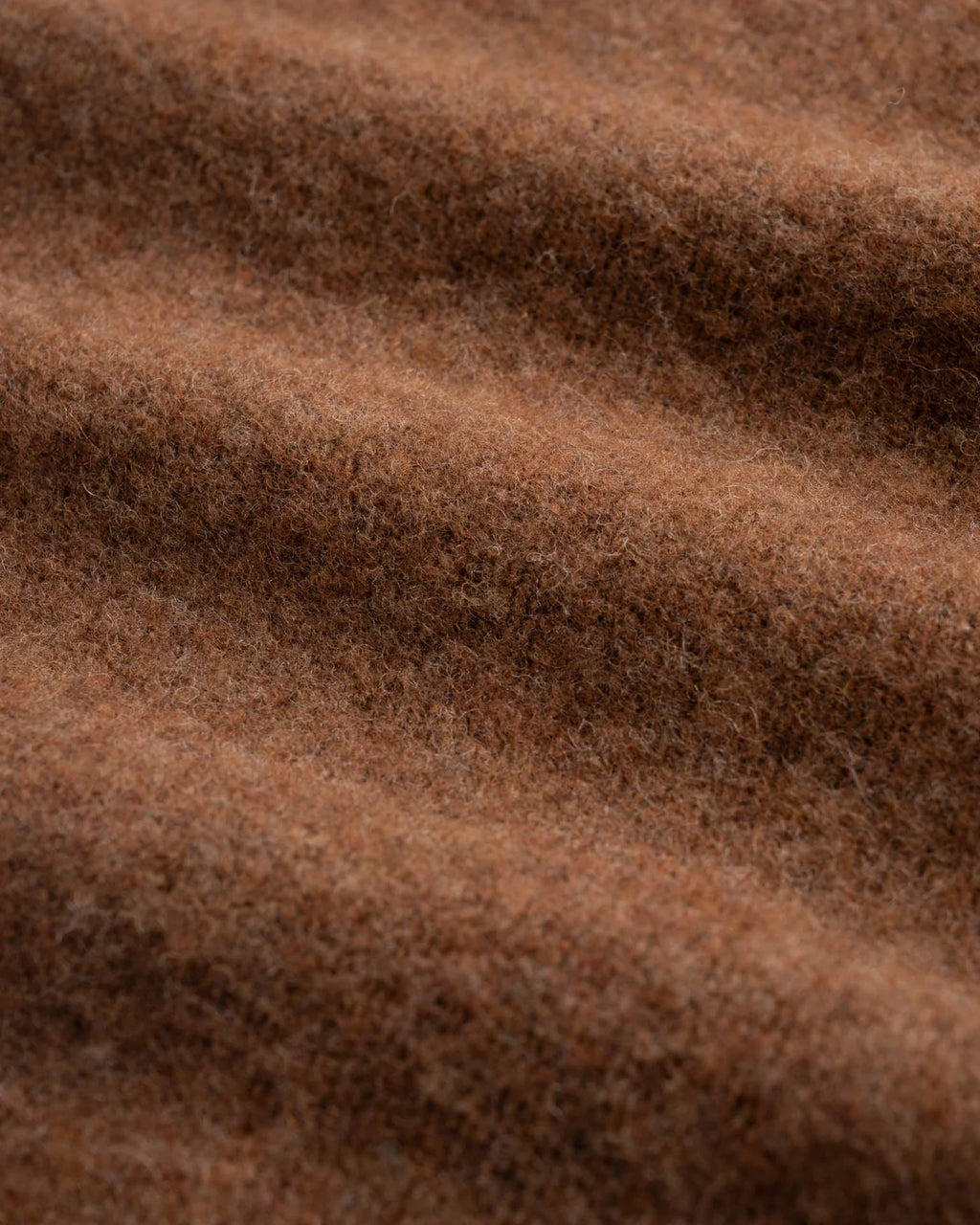 Close up of brown shetland wool sweater fabric in waves. See product description for more details.